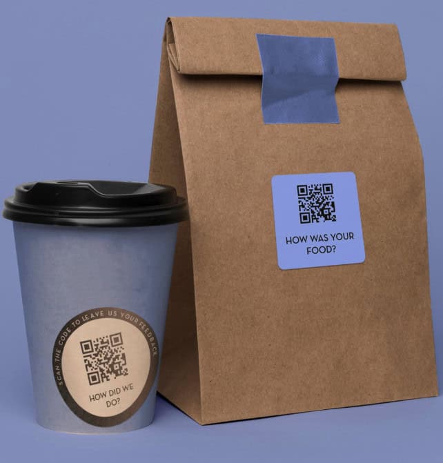 A paper coffee cup and a brown paper bag, both with QR code stickers for Restaurant Survey Collection. The bag's sticker says, "HOW WAS YOUR FOOD?" and the cup's says, "HOW DID WE DO?" on a purple background.